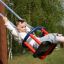 Kid swinging on Wooden Baby Swing