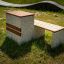 Libra outdoor bench with concrete and wooden elements in a park setting