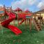 Space Station castle with slide, outdoor playground equipment with red slides and climbing structure