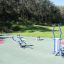 Outdoor gym equipment in a park setting.