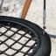 Close-up of Single Swing (BNS 90cm) with black net seating and metal chains on a sandy playground.