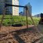 Single Swing (BNS 90cm) in a playground with a wooden frame