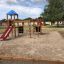 Children's playground with climbing booth and slide.