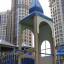 Citadel castle with slide on playground with tall buildings in background
