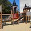 Citadel castle with slide in a playground setting with children playing