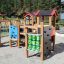 Alpha playhouse with slide in an outdoor playground setting