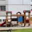 Alpha playhouse with slide in a playground setting