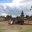 Outdoor Campanille playground castle with slide and climbing features.