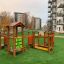 Playground structure Trixie in residential area with green artificial grass.