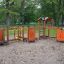 Outdoor playground equipment Trixie with multiple activity stations in a park setting.