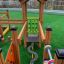 Children's playground equipment Trixie with wooden climbing structures and tic-tac-toe game.