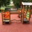 Children's playground equipment Trixie with slides and climbing structures in a park.