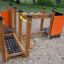 Playground equipment Trixie with climbing and educational elements in a sandbox.