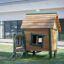 Wooden playhouse Britta's Playhouse with ladder and slide.