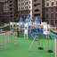 Double Tyre double swing on a playground with castle-themed structures.