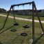 Double Tyre double swing on a grassy playground.