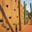 Wooden wall with climbing holds, part of the Spillikins wooden playhouse.