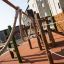 Spillikins wooden playhouse with climbing ropes and outdoor playground structure.