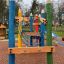 Crayons wooden playhouse climbing structure with colorful pencil-shaped posts and rope bridge on a p