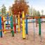 Colorful Crayons wooden playhouse on a sandy playground.