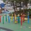 Wooden playhouse Crayons themed playground equipment in a park.