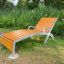 Cannes Deck Chair made of wood and metal in a garden.