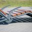 Marseille Deck Chair with wooden slats and metal frame on a paved surface.