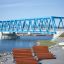 Montpellier Deck Chair by the river with a blue bridge in the background