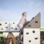 A child climbing on Climbing cubes playground structure.