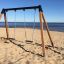 Double Safety Seat double swing set on a sandy beach by the sea