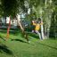 Double Safety Seat double swing on a playground with wooden frame
