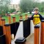 Child playing on the Theseus wooden playground structure.