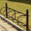 Bike Stand - black metal bike rack with four circular holders.