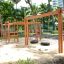 Wooden Tire double swing in a playground surrounded by trees