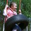 Girl swinging on Wooden Tyre Swing