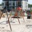 Triple swing set for kids in a modern playground.