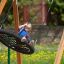 Child swinging on Triple swing in a playground.
