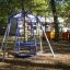 Wheelchair Swing in a playground setting among trees