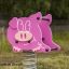 Pink pig-shaped playground rocker with a spring base, named Piggy rocking.