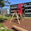 Bench, Steel Construction in a modern playground with apartment buildings in the background