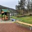 Bench, Steel Construction in a children's playground with green surroundings