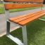 Tallin Bench w/ Backrest on grass near pathway