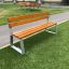 Tallin Bench w/ Backrest on a grass patch near a pathway.