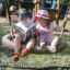 Children enjoying a ride on a Nature Swing Frame BNS+2 (multiple swing) outdoors.