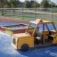 Sandbox playground with yellow taxi-themed play structure for children.