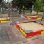 Playground with Sandbox sandboxes surrounded by benches and trees