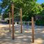 Outdoor fitness station with Pull Bars for exercise in a park setting.