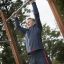 Man using Pull Bars outdoor fitness equipment.