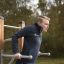 Man exercising on the Bars II outdoor fitness equipment.