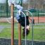 Bars II outdoor fitness equipment with a person hanging upside down
